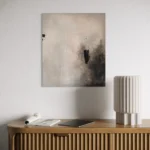 šedo-černý abstraktní obraz nad komodou